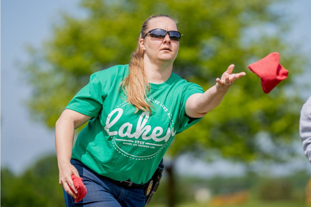 A player throws a bag wearing a green Laker shirt